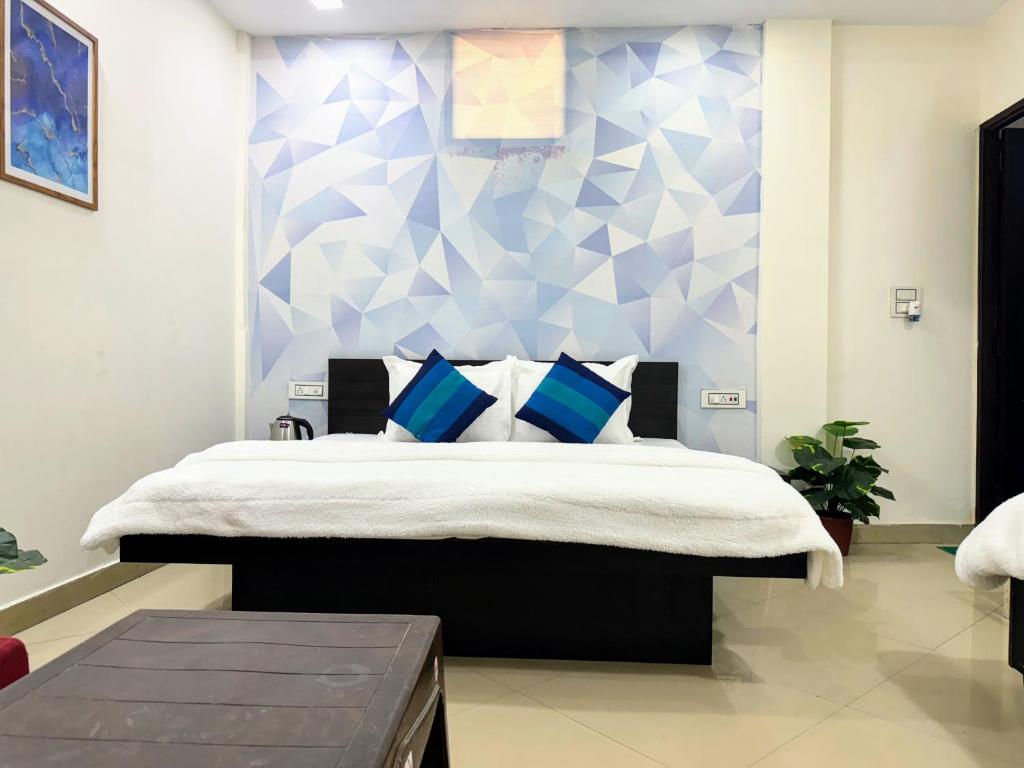 Family Suite with king bed, geometric blue accent wall, and bright airy interiors