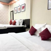 Triple room with two beds and red accent pillows