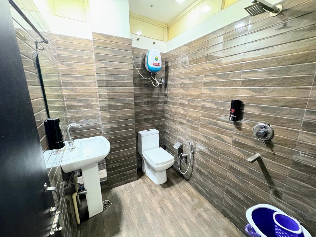 Modern private washroom with shower, toilet, and water heater
